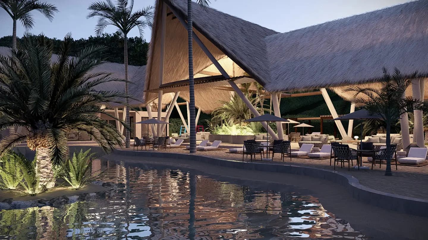 Piscina iluminada frente al club house al anochecer