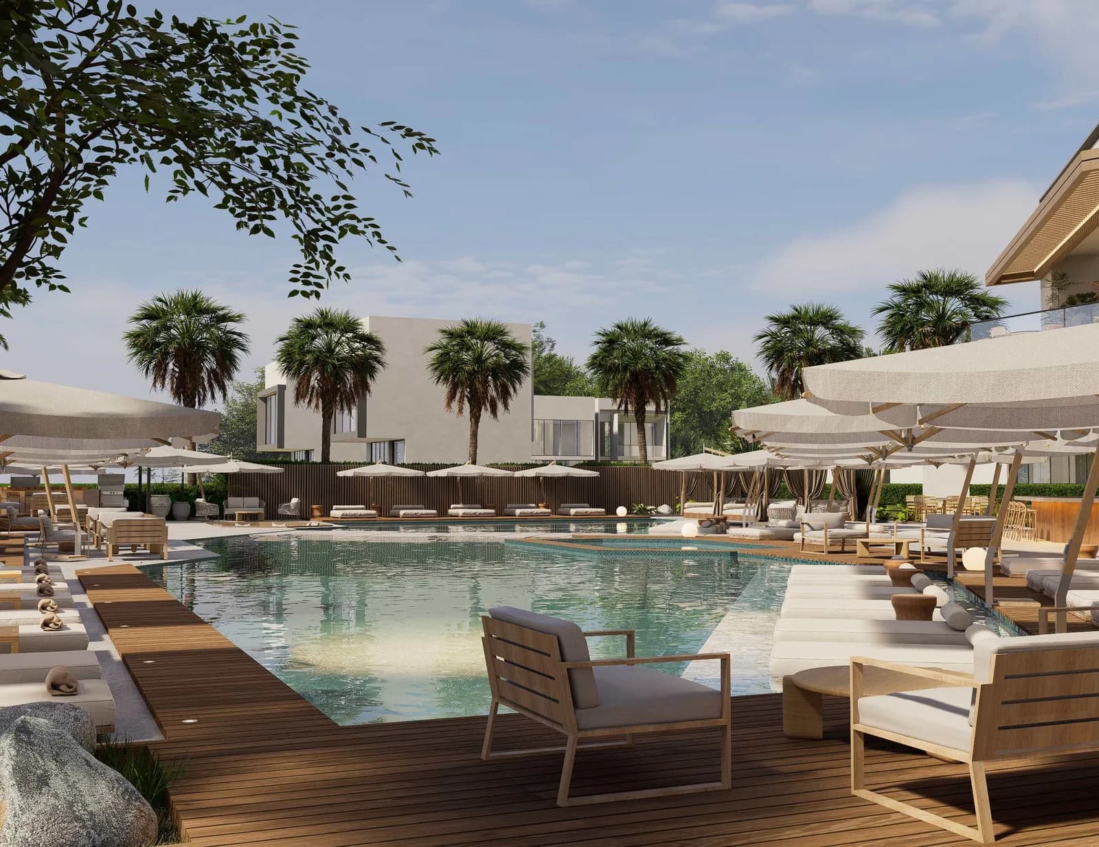 Piscina del club social rodeada de palmeras y deck lounge